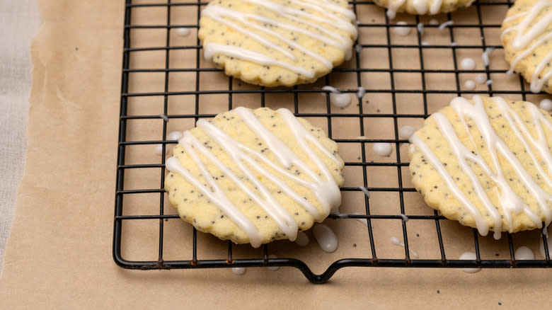 lemon poppyseed shortbread cookies with icing on wire rack