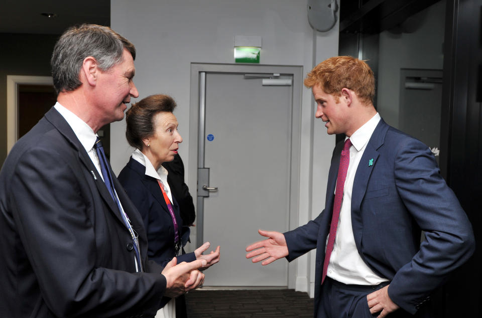 Prince Harry speaks with Princess Anne, the Princess Royal and her husband Timothy Laurence as they arrive for the Olympic Games 2012 Opening Ceremony on July 27, 2012 in London, England. Athletes, heads of state and dignitaries from around the world have gathered in the Olympic Stadium for the opening ceremony of the 30th Olympiad. London plays host to the 2012 Olympic Games which will see 26 sports contested by 10,500 athletes over 17 days of competition. (Photo by John Stillwell - WPA Pool/Getty Images)