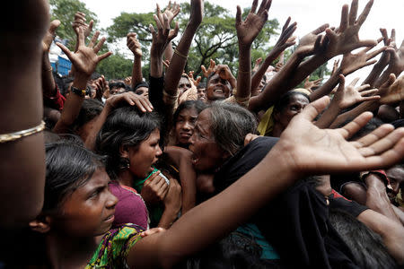 Rohingya refugees react as aid is distributed in Cox's Bazar, Bangladesh, September 21, 2017. REUTERS/Cathal McNaughton