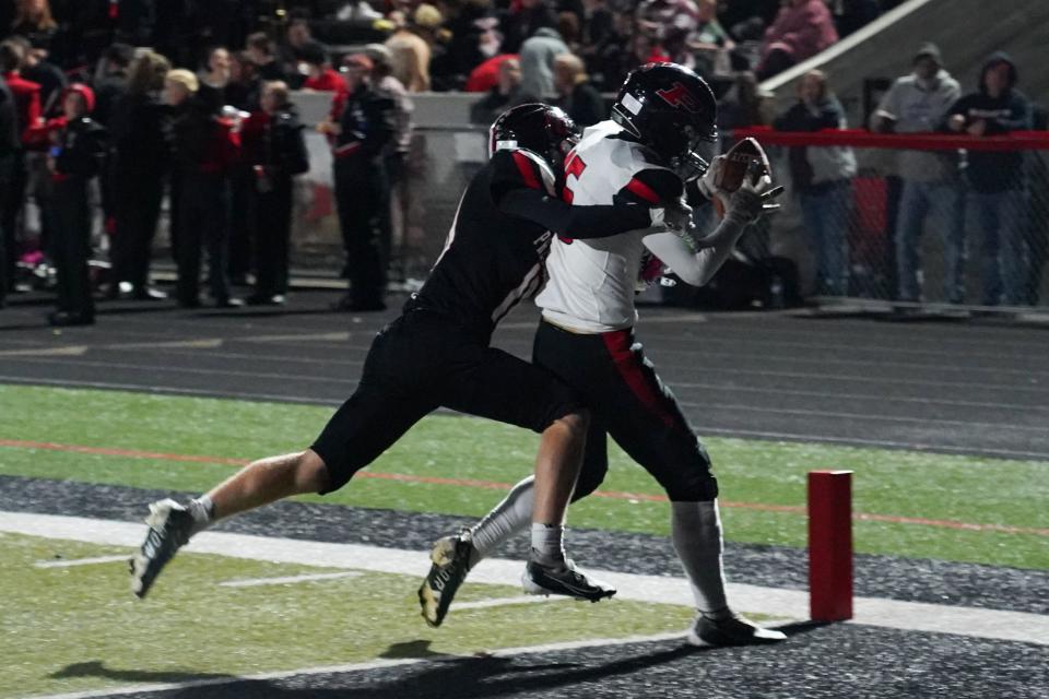 Pleasant's Devon Horn reels in a touchdown pass Friday night in a football game at Marion Harding.