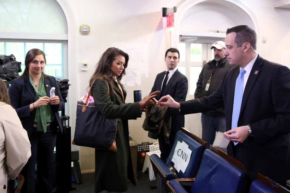 Reporters get a sticker from a U.S. Secret Service agent once they are cleared to cover the Trump administration's daily coronavirus briefing after having their temperature checked a second time at the White House in Washington, U.S. March 17, 2020.  (Jonathan Ernst/Reuters)