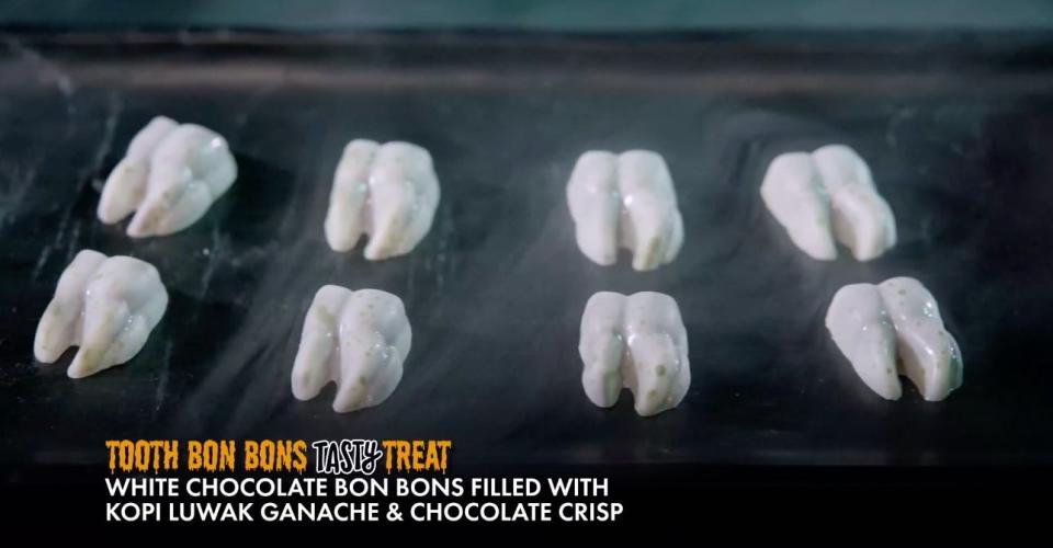 tooth shaped treats with text 'white chocolate bon bons filled with kopi luwak ganache & chocolate crisp'