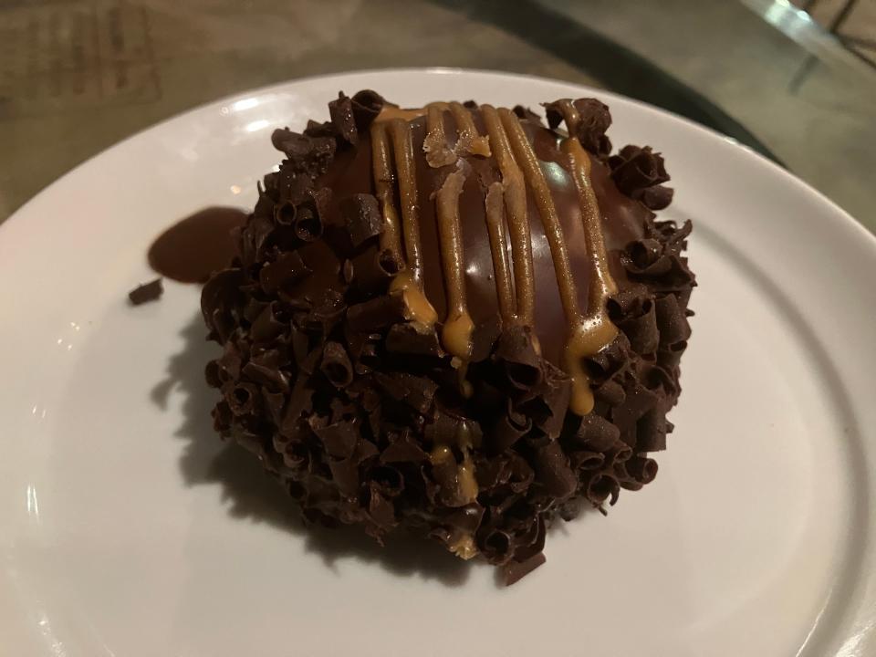 A peanut butter mousse bomb from 35º Brix. The bottom layer is chocolate cake, which is then topped with a light peanut butter mousse and covered in a chocolate ganache.