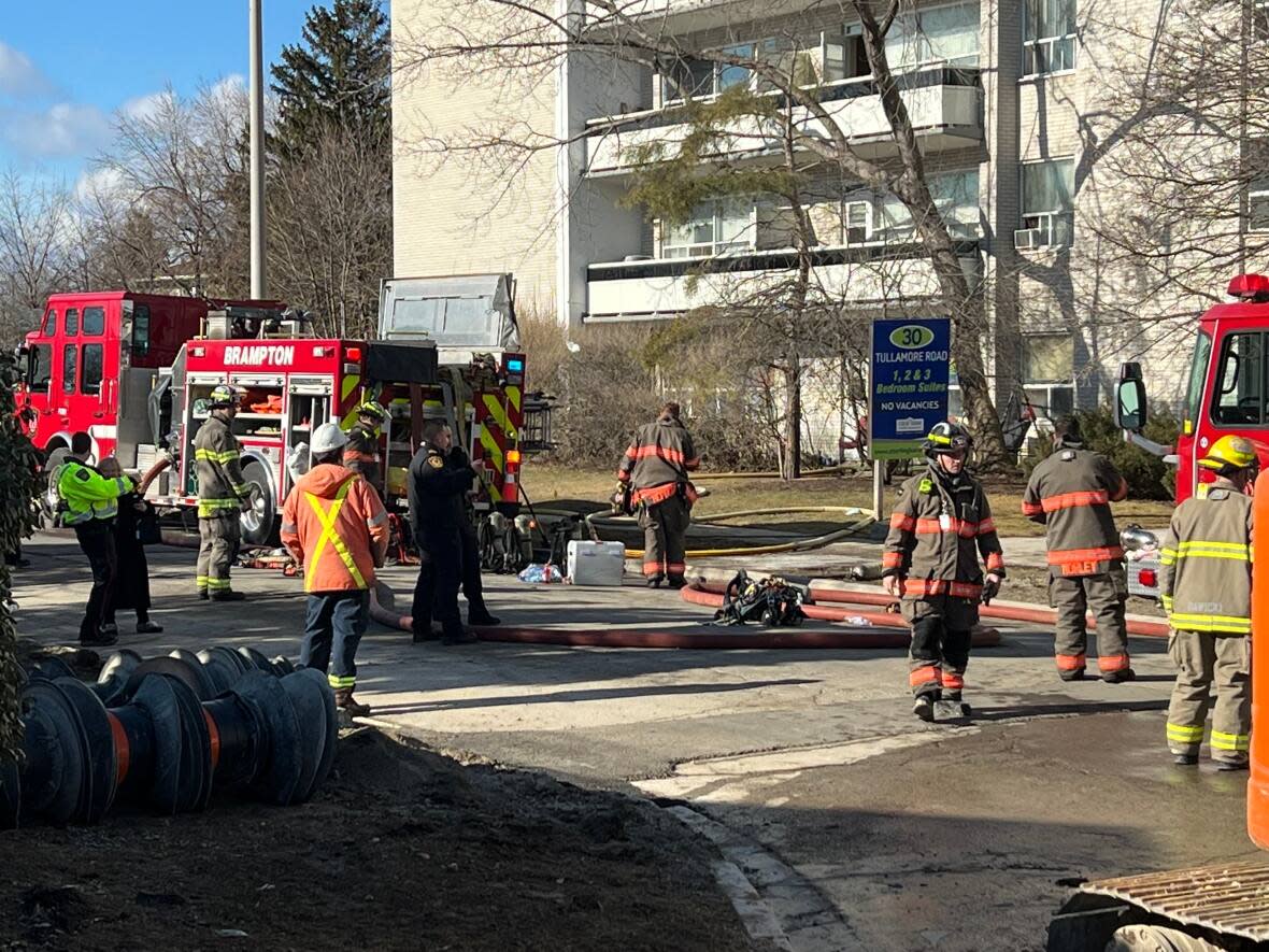 First responders at the scene of an apartment fire Monday morning that left one man dead and several others suffering from smoke inhalation. (Rob Krbavac/CBC - image credit)