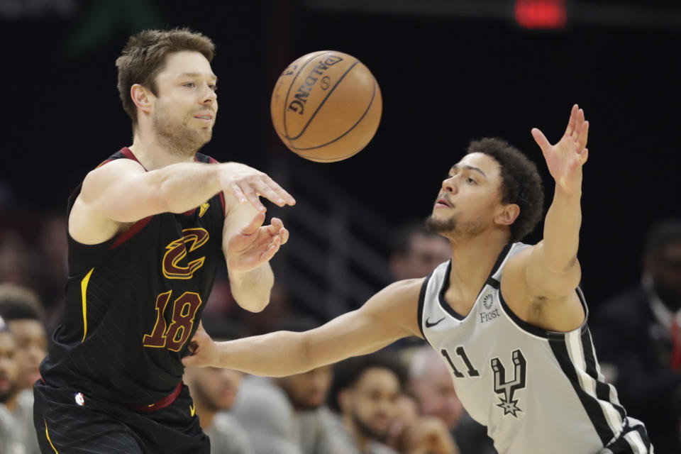 FILE - In this March 8, 2020, file photo, Cleveland Cavaliers' Matthew Dellavedova (18) passes against San Antonio Spurs' Bryn Forbes (11) in the second half of an NBA basketball game in Cleveland. The Cavaliers are nearing a deal with free agent guard Dellavedova, one of the Cavs' most popular players. (AP Photo/Tony Dejak, File)