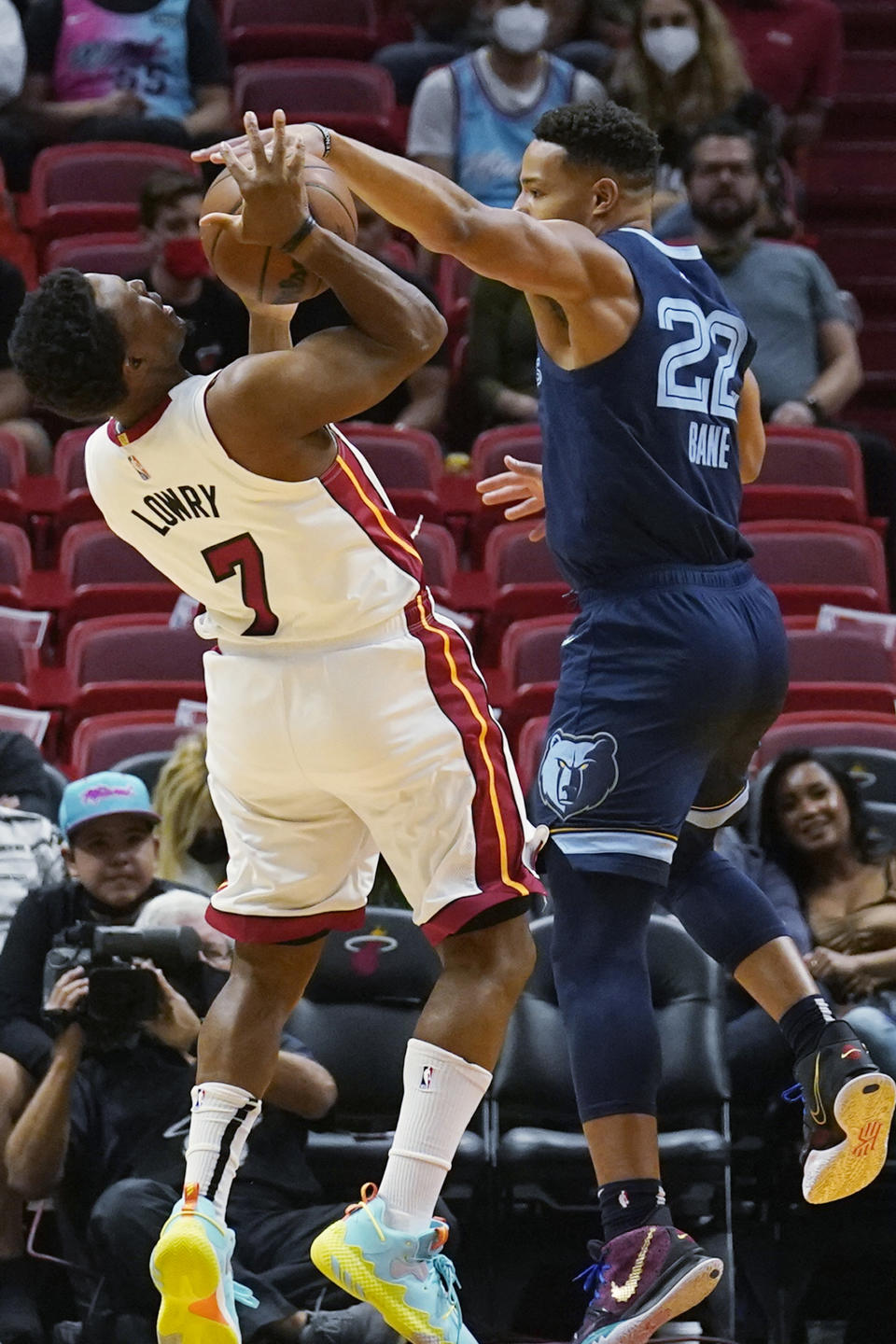 Memphis Grizzlies guard Desmond Bane (22) blocks a shot to the basket by Miami Heat guard Kyle Lowry (7) during the first half of an NBA basketball game, Monday, Dec. 6, 2021, in Miami. (AP Photo/Marta Lavandier)