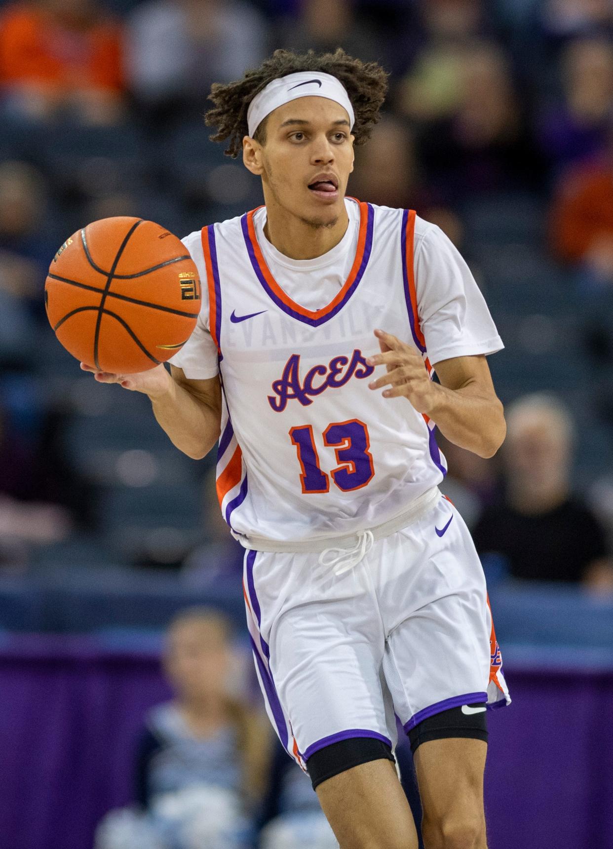 Evansville’s Blaise Beauchamp (13) dribbles the ball as the University of Evansville Purple Aces play the Oakland City Mighty Oaks at Ford Center in Evansville, Ind., Saturday, Oct 29, 2022.