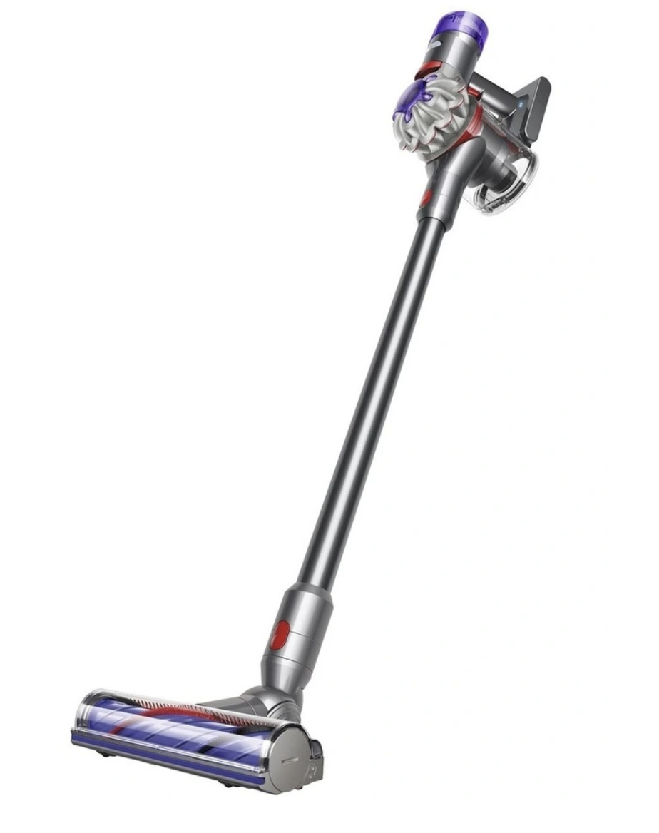 A grey and purple stick vacuum with red trim sits against a plain white background.