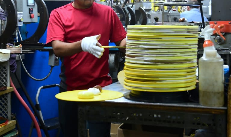 Employees at Erika Records work in the record pressing plant in Buena Park, California on April 12, 2017, where Erika Records has been pressing vinyl in its record manufacturing business for over 30 years