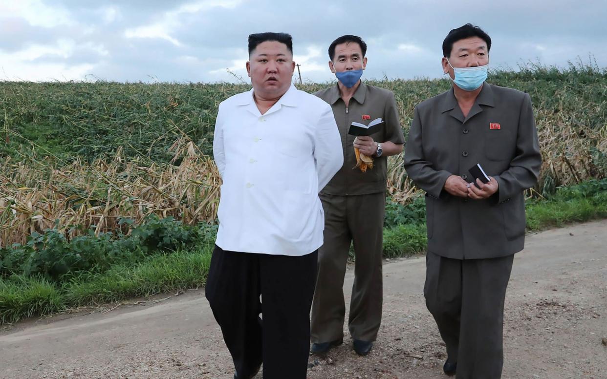 North Korean leader Kin Jong-un visits a typhoon-stricken area in the summer - AFP