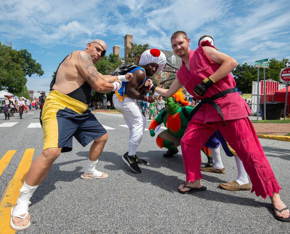 Participates dressed in character at the Dover Comic Con Festival in downtown Dover.