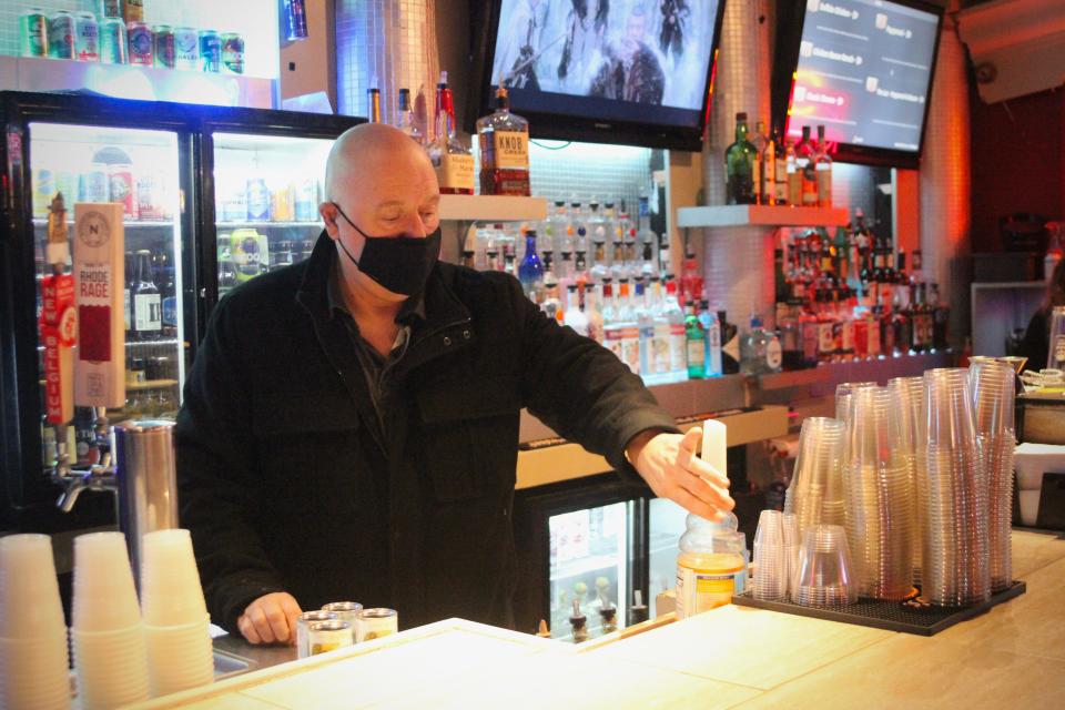 Anthony Santurri behind the bar at Freeplay Bar and Arcade in Providence, which he owns. Santurri says that many bar owners struggle to bring in customers between 4:30 and 6 p.m.