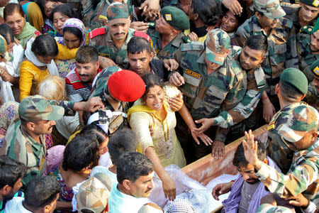 Geeta (C), wife of Ravi Paul, an Indian army soldier who was killed in Sunday's attack at an Indian army base in Kashmir's Uri, reacts upon seeing the body of her husband in Sarwa village in Samba district, south of Jammu, September 19, 2016. REUTERS/Mukesh Gupta