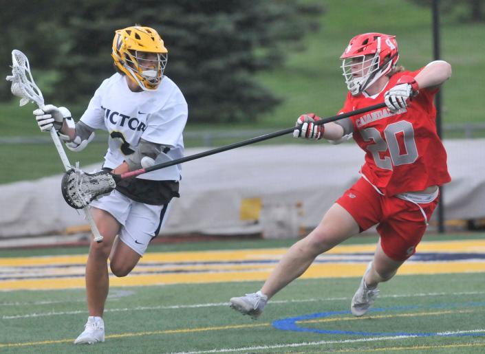 Victor&#39;s Jack Herendeen (2) protects the ball as Canandaigua&#39;s Eric Platten defends during Thursday&#39;s game.