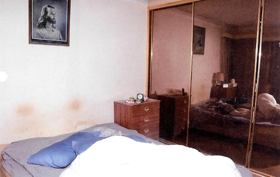 Another image of Shirley Thompson's bedroom where her bed is reflected in the wardrobe's mirror.