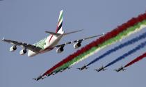 An Emirates Airline A-380 leads the "Al Fursan", or the Knights, a UAE Air Force aerobatic display team during the opening day of the Dubai Airshow, in Dubai, United Arab Emirates, Sunday, Nov. 17, 2019. The biennial airshow opened as major Gulf airlines rein back big-ticket purchases after a staggering $140 billion in new orders were announced at the 2013 show before global oil prices collapsed. (AP Photo/Kamran Jebreili)