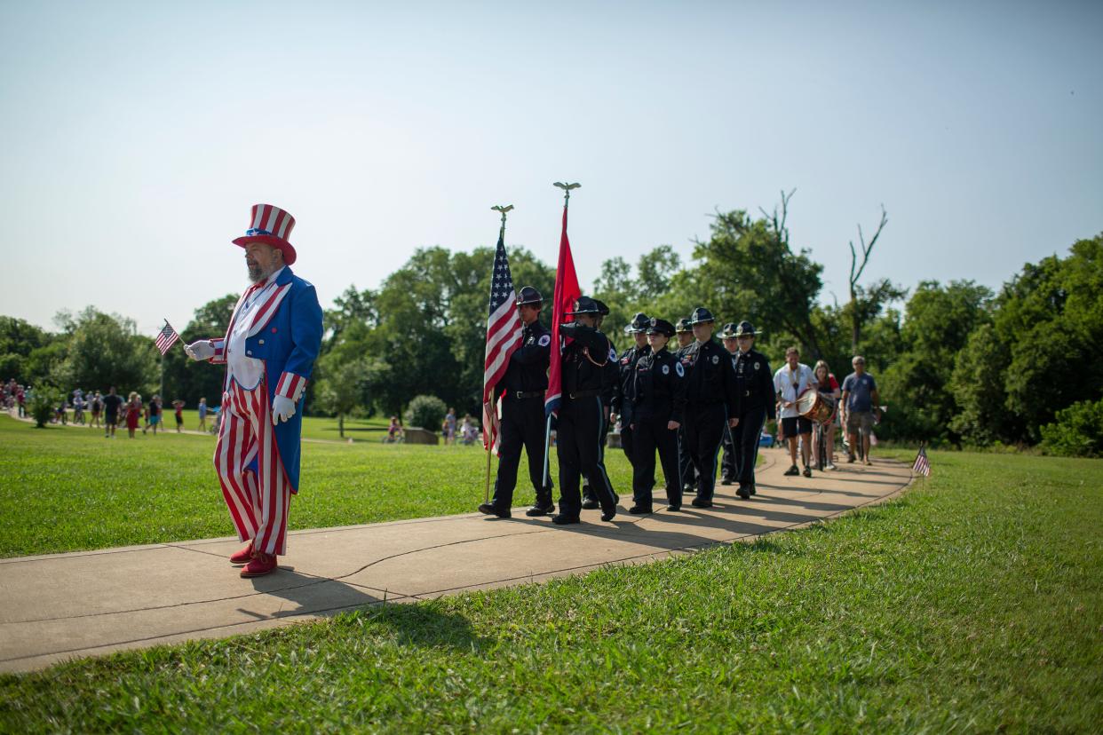 Columbia Rotarian and Maury County Commissioner Eric Previti leads a bike parade dressed as Uncle Sam during an Independence Day celebration at Riverwalk Park in Columbia, Tenn., on Saturday, July 3, 2021.