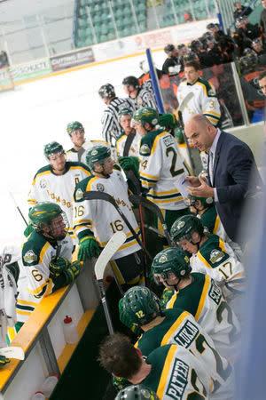 Head coach Darcy Haugan talks to the 2017-2018 Humboldt Broncos Saskatchewan Junior Hockey League team on the bench during a game in this undated handout photo. Amanda Brochu/Handout via REUTERS