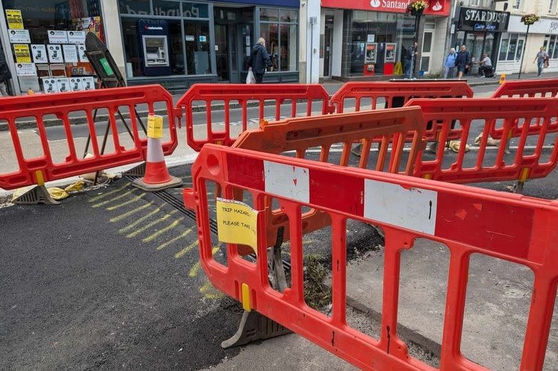 Sign warning people of trip hazard in Queen Street Newton Abbot