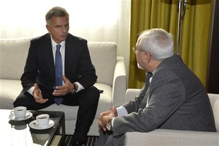 Swiss Foreign Minister Didier Burkhalter (L) talks to Iranian Foreign Minister Mohammad Javad Zarif during a private meeting before the start of the second day of closed-door nuclear talks at the United Nations offices in Geneva October 16, 2013. REUTERS/Martial Trezzini/Pool