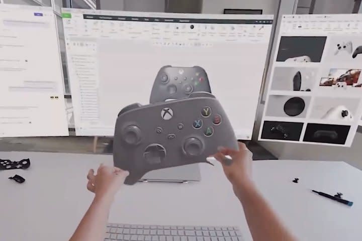 A person holds a virtual Xbox controller in VR.