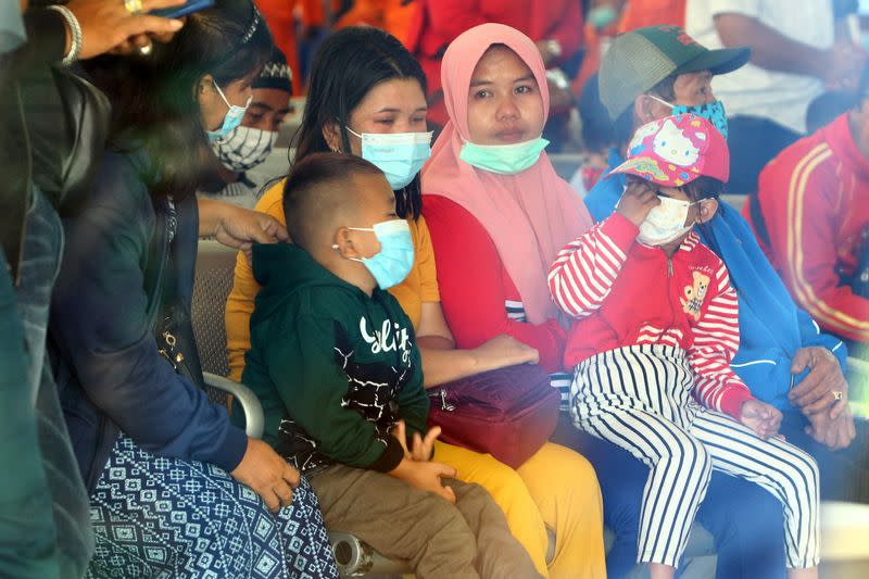 Family members of a Sriwijaya Air passenger react after the Flight SJ182 Boeing 737-500 crashed after taking off at Supadio Airport