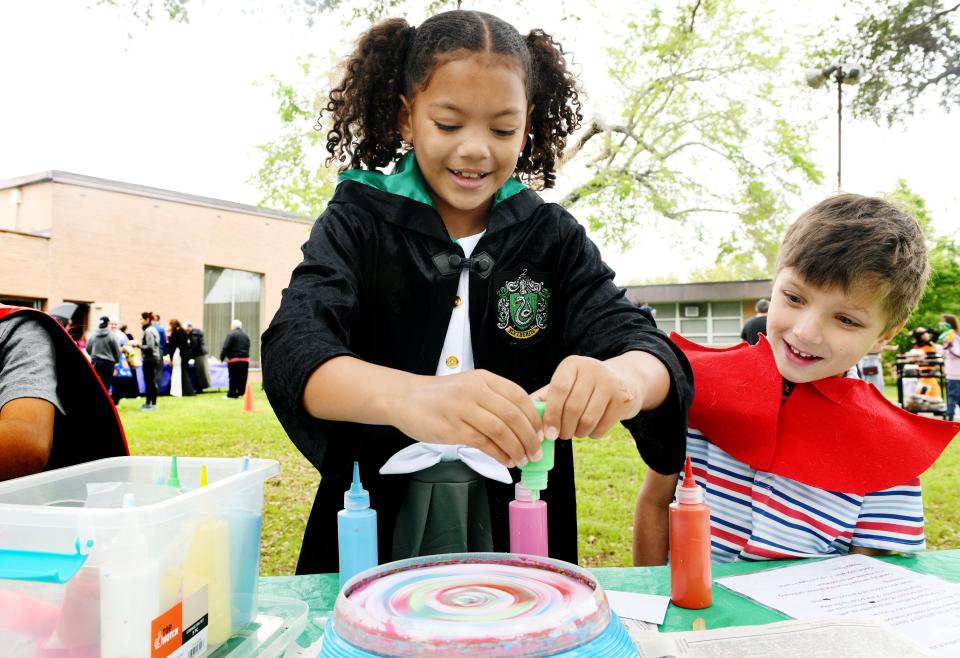 Kyah Hunter makes spin art as Elias Hicks watches during the North Louisiana Jewish Federation's Purim Carnival at the B'nai Zion Congregation Sunday afternoon, March 24, 2024.