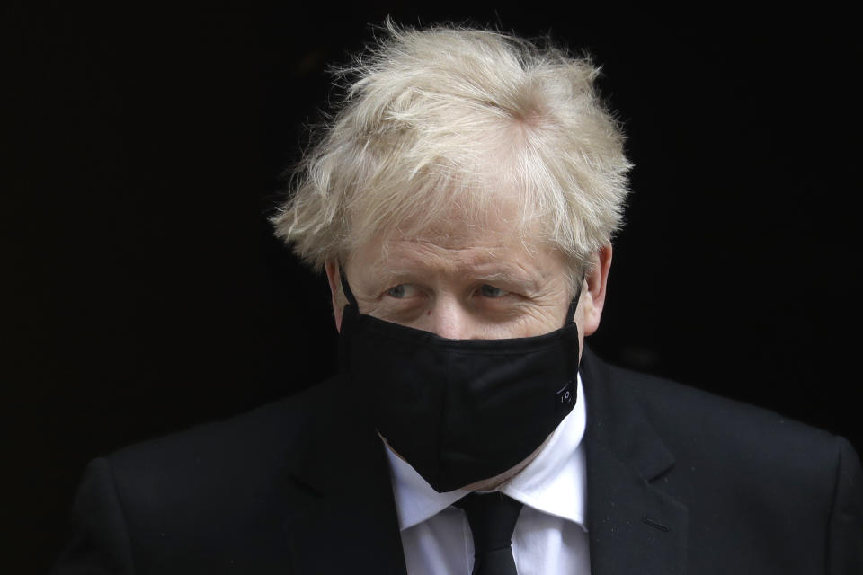 Britain's Prime Minister Boris Johnson leaves 10 Downing Street to attend the weekly session of Prime Ministers Questions in Parliament in London, Wednesday, April 14, 2021. (AP Photo/Kirsty Wigglesworth)