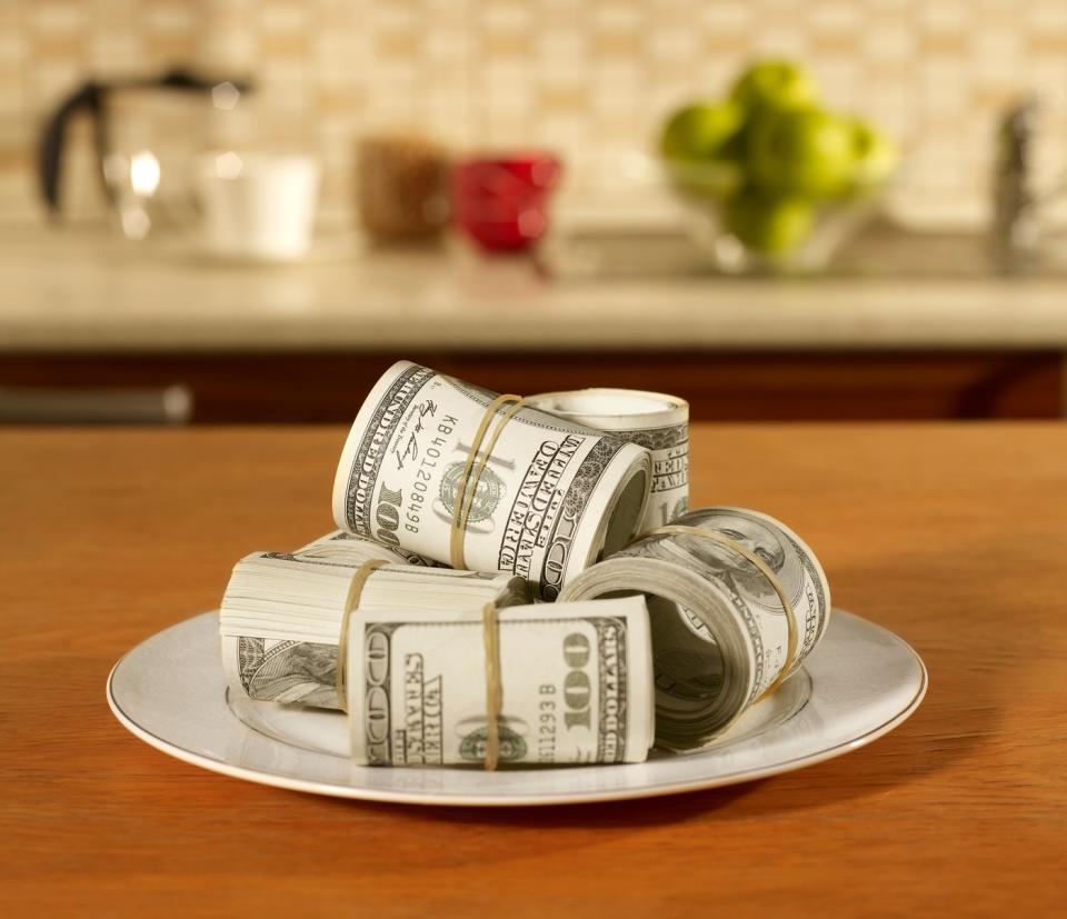 Rolls of U.S. currency piled on a plate.