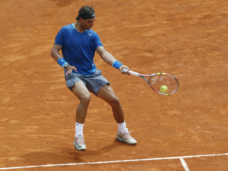 Rafael Nadal of Spain returns the ball to David Ferrer of Spain during their quarterfinals match of the Monte Carlo Tennis Masters tournament in Monaco, Friday, April 18, 2014. Ferrer won 7-6 6-4. (AP Photo/Michel Euler)