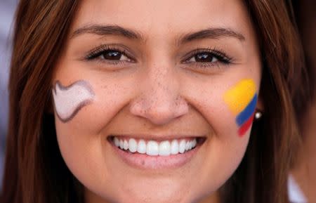 A woman smiles as she gathers with others at the Bolivar square outside the cathedral in Bogota, Colombia, September 26, 2016. REUTERS/Felipe Caicedo