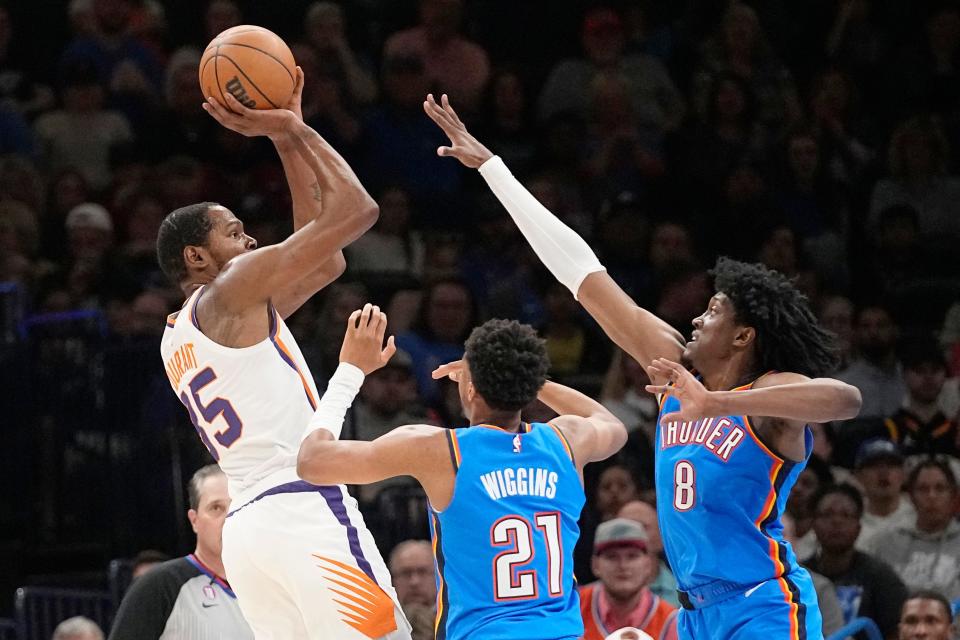 Phoenix Suns forward Kevin Durant (35) shoots over Oklahoma City Thunder guard Aaron Wiggins (21) and forward Jalen Williams (8) in the first half of an NBA basketball game Sunday, April 2, 2023, in Oklahoma City. (AP Photo/Sue Ogrocki)