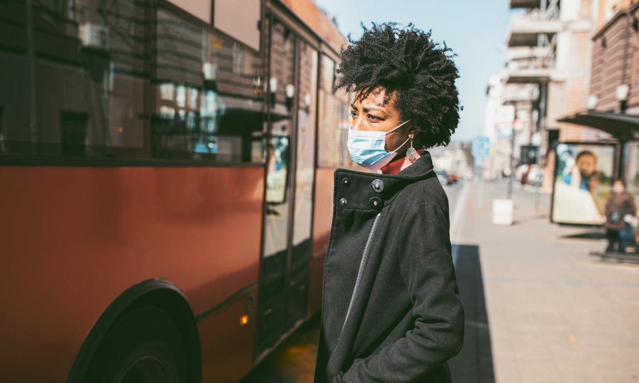 <span class="caption">The economic impact of coronavirus restrictions can also take a human toll.</span> <span class="attribution"><a class="link " href="https://www.gettyimages.com/detail/photo/portrait-of-young-woman-with-mask-on-the-street-royalty-free-image/1213302709" rel="nofollow noopener" target="_blank" data-ylk="slk:mladenbalinovac via Getty Images;elm:context_link;itc:0;sec:content-canvas">mladenbalinovac via Getty Images</a></span>