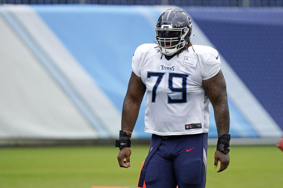 FILE - In this Friday, Aug. 21, 2020, file photo, Tennessee Titans offensive tackle Isaiah Wilson waits for his turn to run a drill during NFL football training camp in Nashville, Tenn. A person familiar with the deal said Monday, March 8, 2021, that the Tennessee Titans have traded offensive lineman Wilson to the Miami Dolphins in a move unloading their first-round draft pick after his rookie season. (AP Photo/Mark Humphrey, Pool, File)