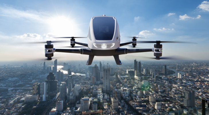Autonomous driverless aerial vehicle flying on city background, Future transportation with 5G technology concept. EH stock