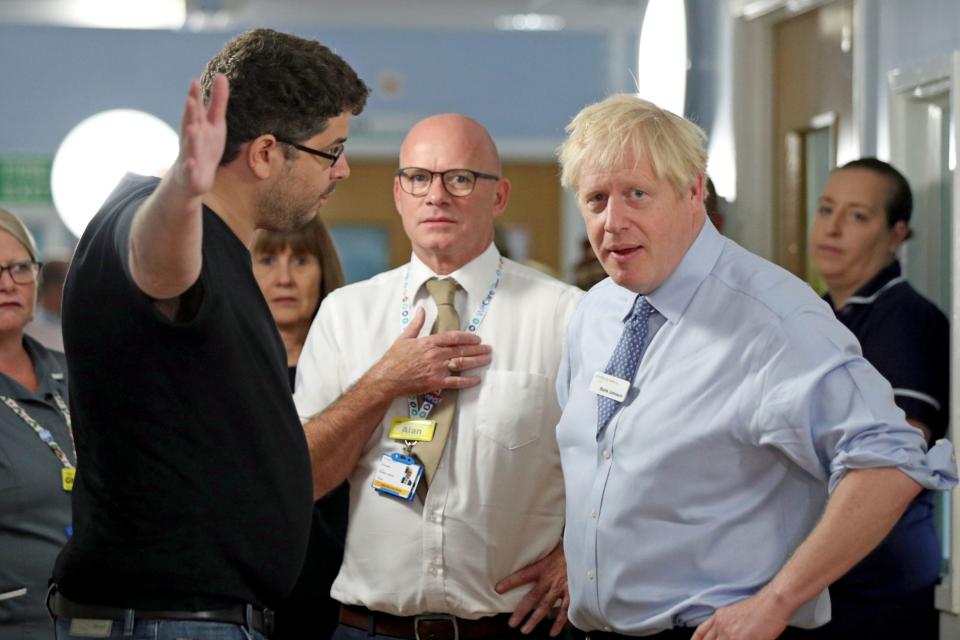 An angry parent confronts Boris Johnson (PA)