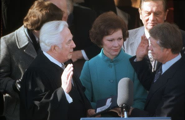 WASHINGTON DC - JANUARY  1977; President Jimmy Carter with wife Rosalyn Carter, takes the oath of office from Chief Justice of the Supreme Court Warren Burger on stage in front of the White House  in January 1977; (Photo by Nik Wheeler/Corbis via Getty Images)