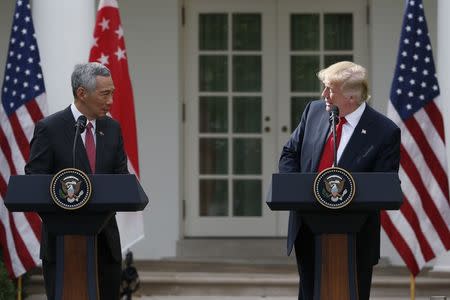 Singapore's Prime Minister Lee Hsien Loong and U.S. President Donald Trump give joint statements in the Rose Garden of the White House in Washington, U.S., October 23, 2017. REUTERS/Joshua Roberts