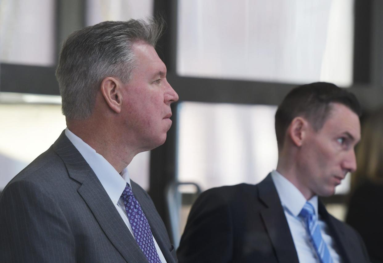 Former state police Col. Richard D. McKeon, left, listens to testimony next to his lawyer Michael Rusconi on April 13, 2022.