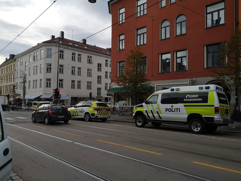 Police cars are seen at the scene where an armed man stole an ambulance in Oslo