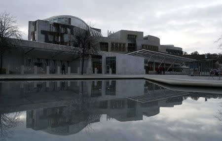 The Scottish Parliament is reflected in a pond in Holyrood Edinburgh, Scotland March 10, 2017. REUTERS/Russell Cheyne