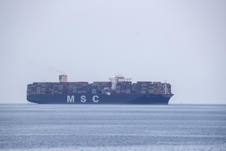 A cargo ship approaches the port of Piraeus near Athens, Greece, Tuesday, May 26, 2020. During the new coronavirus pandemic, about 150,000 seafarers are stranded at sea in need of crew changes, according to the International Chamber of Shipping. Roughly another 150,000 are stuck on shore, waiting to get back to work. (AP Photo/Petros Giannakouris)