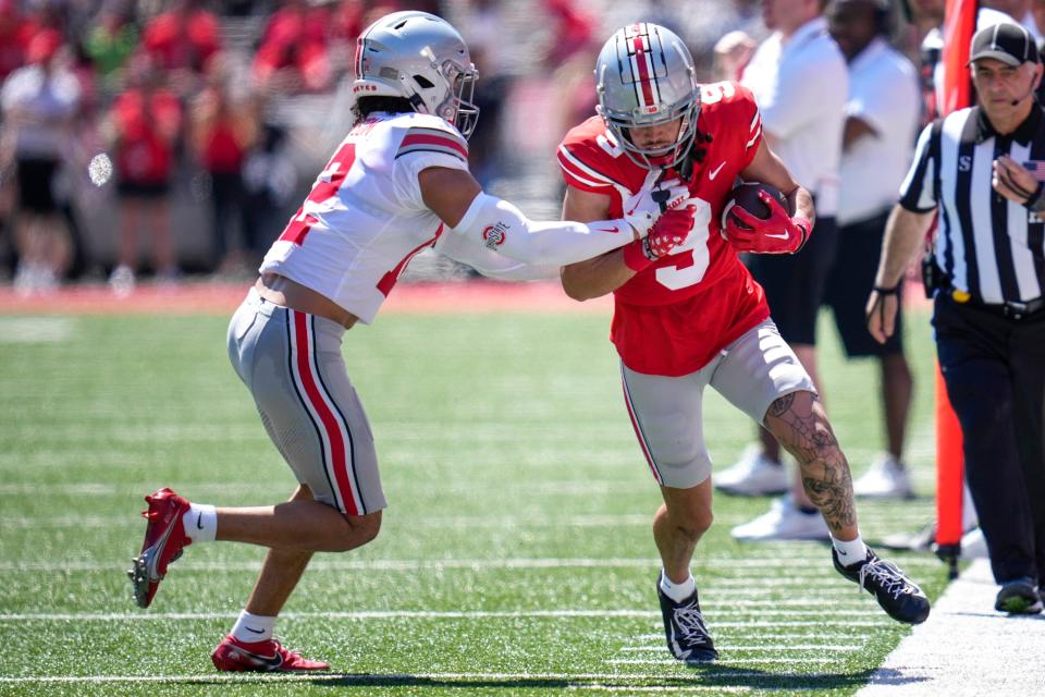 Apr 15, 2023; Columbus, Ohio, United States;  Ohio State Buckeyes safety Lathan Ransom (12) pushes Ohio State Buckeyes wide receiver Jayden Ballard (9) out of bounds during the second quarter of the Ohio State Buckeyes spring game at Ohio Stadium on Saturday morning. Mandatory Credit: Joseph Scheller-The Columbus Dispatch