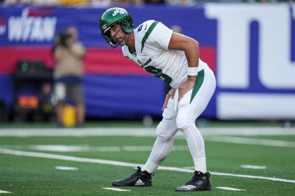 New York Jets quarterback Aaron Rodgers (8) stretches before a play during the first half of an NFL preseason football game against the New York Giants, Saturday, Aug. 26, 2023, in East Rutherford, N.J. (AP Photo/Frank Franklin II)