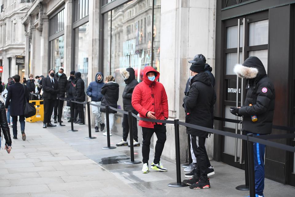 <p>Some shoppers wear face masks as they queue outside Nike Town</p>Jeremy Selwyn