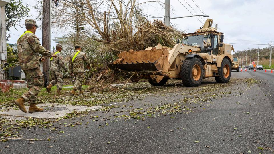 Guam Army National Guardsmen clear debris left by Typhoon Mawar in Agana June 5. A combined joint task force, led by U.S. Army Pacific and Task Force West, is spearheading military contributions to the recovery effort. (Sgt. 1st Class Joshua Brandenburg/Army National Guard)