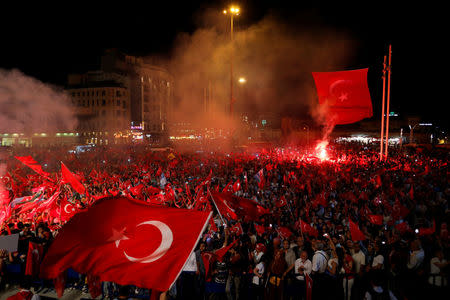 Supporters of Turkish President Tayyip Erdogan wave Turkish national flags during a pro-government demonstration on Taksim square in Istanbul, Turkey, July 18, 2016. REUTERS/Ammar Awad