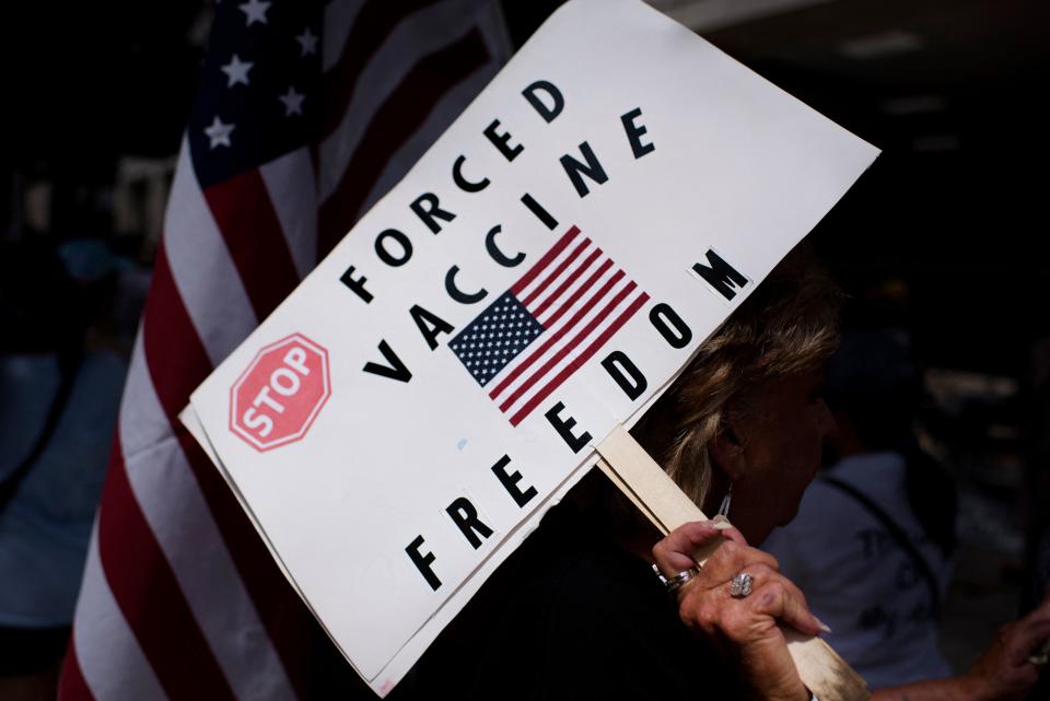 Anti-vaccine rally protesters hold signs outside of Houston Methodist Hospital in Houston, Texas, on June 26, 2021. (Mark Felix/AFP via Getty Images)