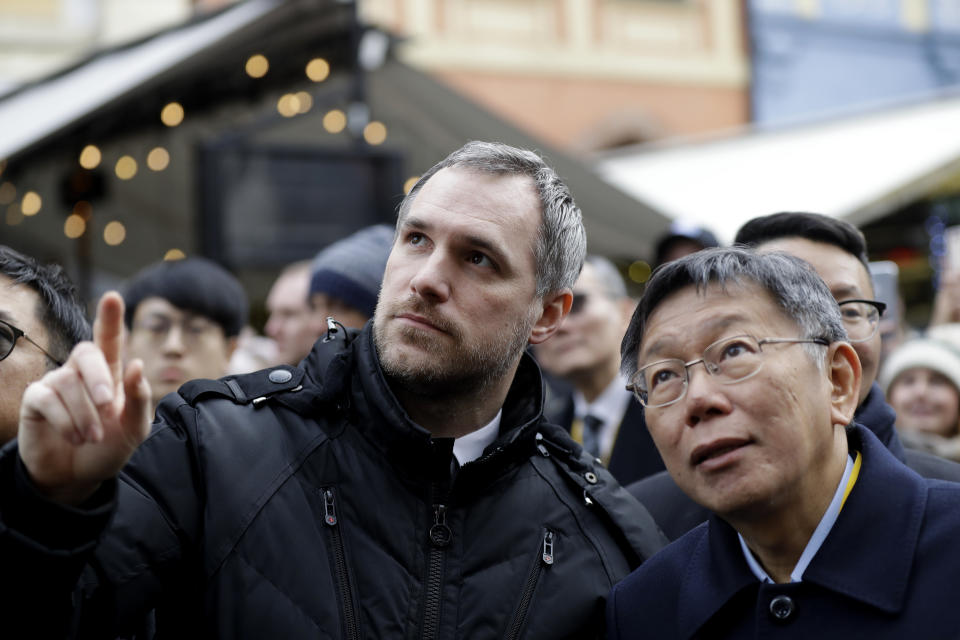 Mayor of Prague Zdenek Hrib, left, and Taipei city mayor Ko Wen-je watch the historical astronomical clock before signing a partnership agreement between the two cities at the Old Town Square in Prague, Czech Republic, Monday, Jan. 13, 2020. The signing comes three months after Prague revoked a similar sister-city agreement with Beijing, an action that angered China. (AP Photo/Petr David Josek)