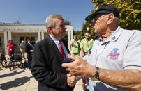 U.S. Senator Dick Durbin (D-IL) (L) shakes hands with veteran Jack Moran of the Chicago Honor Flight at the World War Two Memorial in Washington October 2, 2013. The memorial is technically closed due to the government shutdown, but was opened today and yesterday for visiting veteran groups REUTERS/Kevin Lamarque (UNITED STATES - Tags: POLITICS BUSINESS)